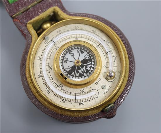 A late Victorian brass travelling barometer, thermometer and compass, cased